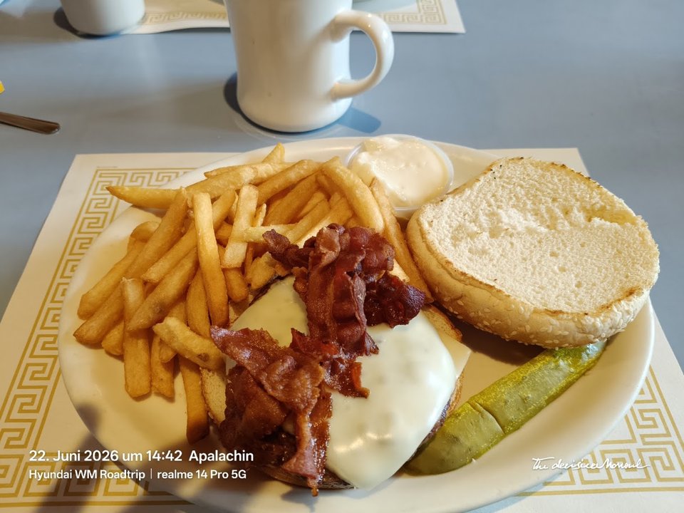 Breakfast plates on tables inside a classic diner setting.